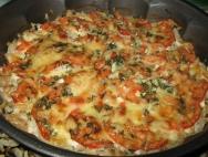 Cod baked in the oven with tomatoes and onions under sour cream sauce